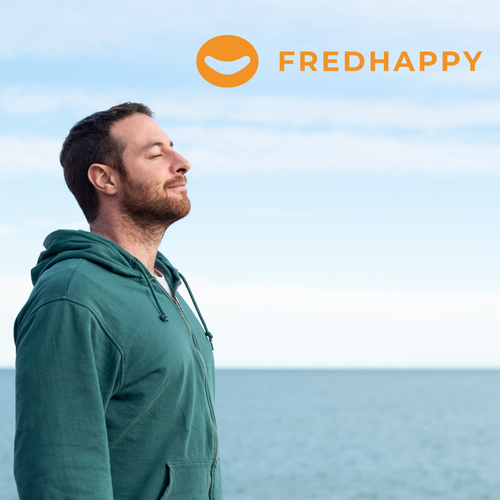 Man taking a deep breath in front of the ocean